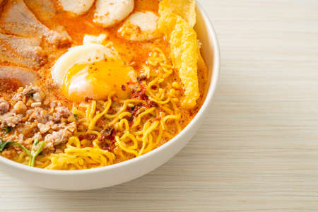egg noodles with pork and meatball in spicy soup or Tom Yum Noodles in Asian style