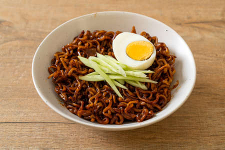 Korean Instant Noodle with Black Bean Sauce topped cucumber and boiled egg (Jajangmyeon or JJajangmyeon) - Korean food styleの写真素材