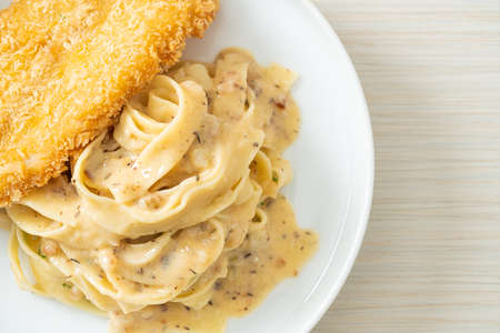 homemade fettuccine pasta white cream sauce with fried fish