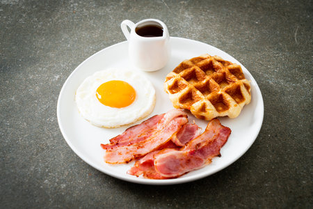 fried egg with bacon and waffle for breakfastの写真素材