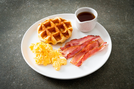 scrambled egg with bacon and waffle for breakfastの写真素材