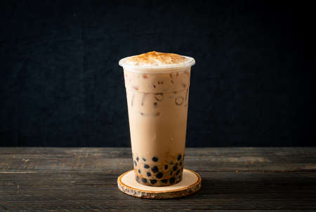 Taiwan milk tea with bubble and cheese burned on wood tableの写真素材