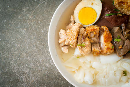 paste of rice flour or boiled Chinese pasta square with pork in clear soup - Asian food styleの写真素材