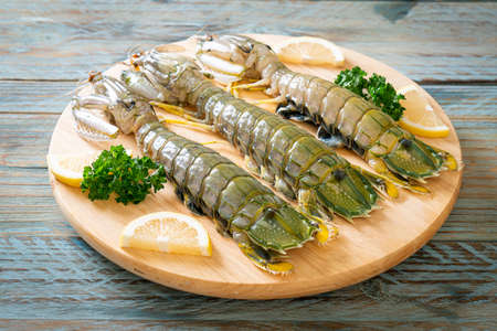 fresh mantis shrimp with lemon on wood boardの写真素材