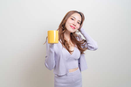 portrait beautiful Asian woman holding coffee cup or mug on white backgroundの写真素材