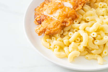Homemade Mac and cheese with fried chickenの写真素材