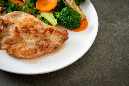 grilled chicken steak with vegetable on white plate
