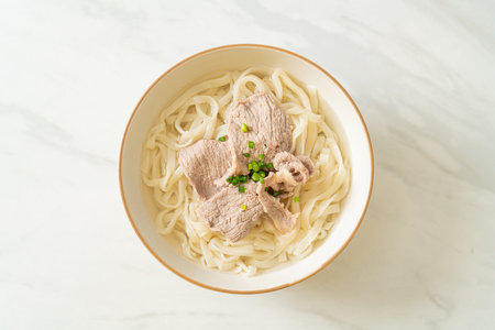 homemade udon ramen noodles with pork in clear soupの写真素材