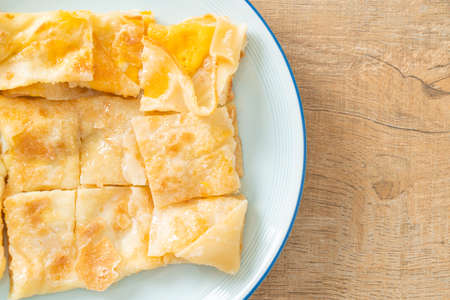 fried roti with egg and sweetened condensed milk