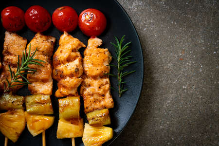grilled chicken barbecue skewer on plateの写真素材