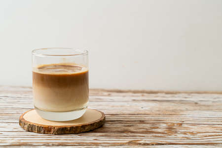 glass of latte coffee, coffee with milk on wood backgroundの写真素材