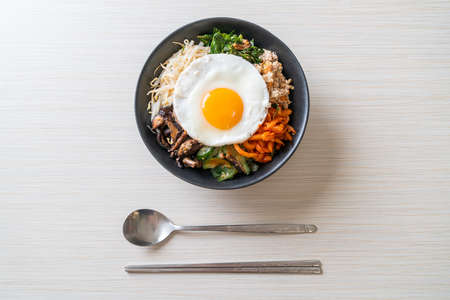 Bibimbap, Korean spicy salad with rice and fried egg - traditionally Korean food styleの写真素材