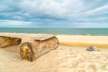 empty wood bench on beach with sea beach backgroundの写真素材