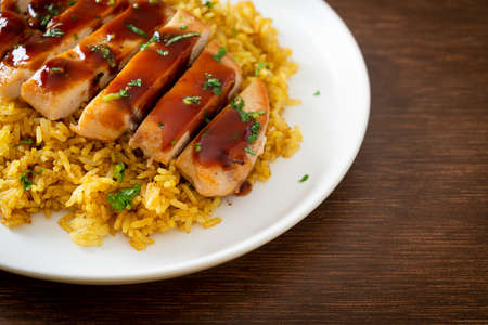 grilled sweet and chilli chicken with curry rice on plateの写真素材