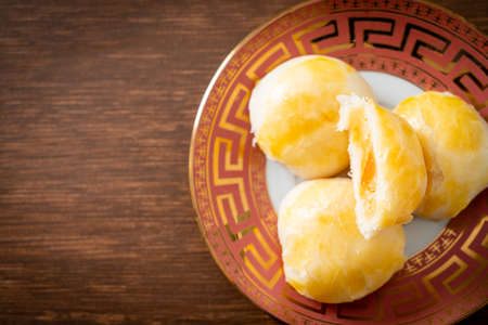 Chinese pastry moon cake with salted egg peanut or Spring Roll pastry with nuts and salted eggs - Asian food styleの写真素材