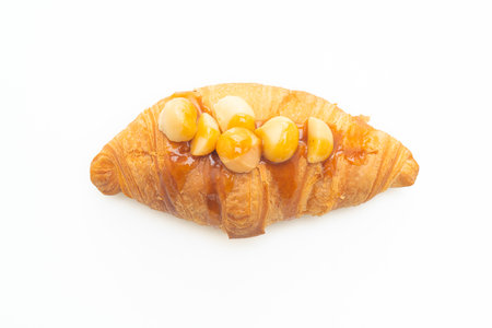 croissant with macadamia and caramel isolated on white backgroundの写真素材