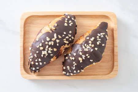 croissant with chocolate and nutty on wood plate