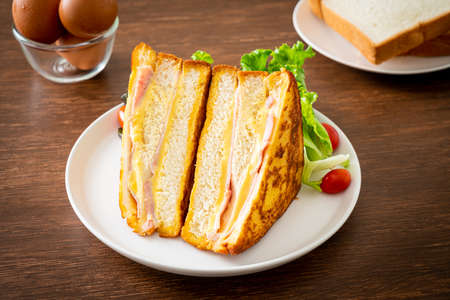 homemade sandwich ham cheese with salad on white plateの写真素材