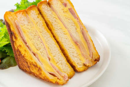 homemade sandwich ham cheese with salad on white plate