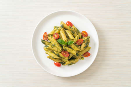 penne pasta with pesto sauce and tomatoes - vegan and vegetarian food styleの写真素材