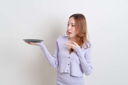 portrait beautiful Asian woman holding empty plate on white backgroundの写真素材