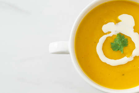 pumpkin soup in white bowl - Vegetarian and vegan food styleの写真素材