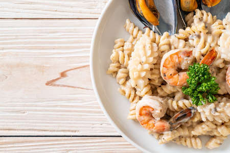 spiral pasta mushroom cream sauce with seafood - Italian food styleの写真素材