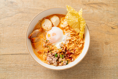 instant noodles with pork and meatballs in spicy soup or Tom Yum Noodles in Asian styleの写真素材