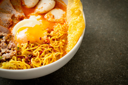 egg noodles with pork and meatball in spicy soup or Tom Yum Noodles in Asian styleの写真素材
