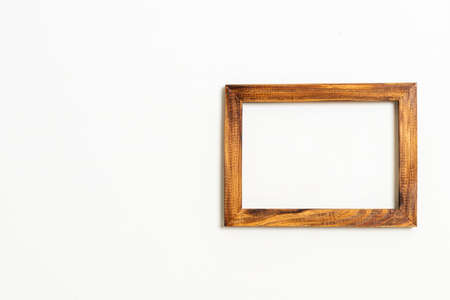empty picture frame on white wall background with copy spaceの写真素材