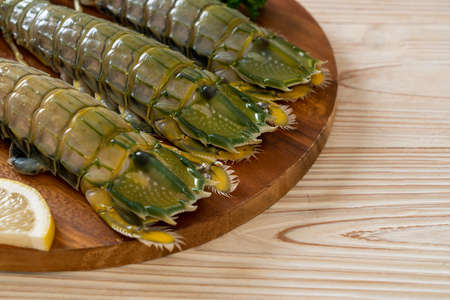 fresh mantis shrimp with lemon on wood boardの写真素材