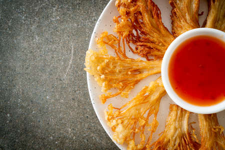 deep fried enoki mushroom or golden needle mushroom with spicy dipping sauce - vegan food styleの写真素材