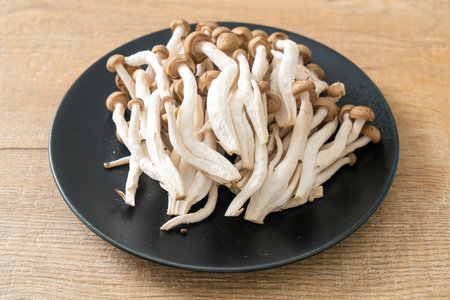 fresh brown beech mushroom or black reishi mushroom on plateの写真素材