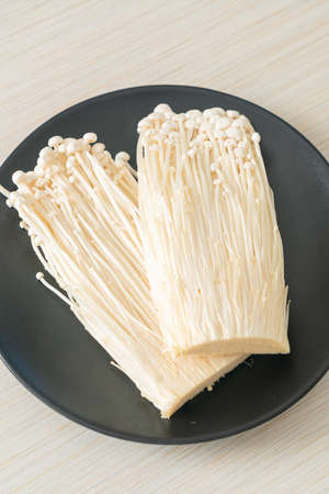 fresh enoki mushroom or golden needle mushrooms on plateの写真素材
