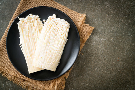 fresh enoki mushroom or golden needle mushrooms on plateの写真素材