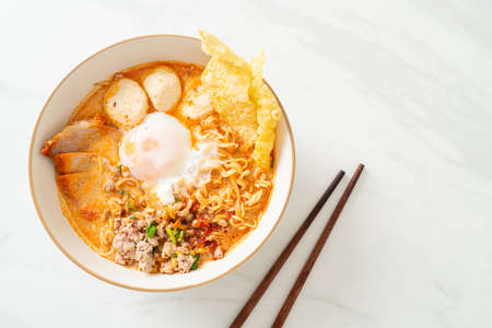 instant noodles with pork and meatballs in spicy soup or Tom Yum Noodles in Asian styleの写真素材