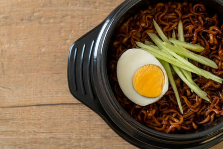 Korean Instant Noodle with Black Bean Sauce topped cucumber and boiled egg (Jajangmyeon or JJajangmyeon) - Korean food styleの写真素材