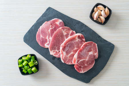 fresh pork neck raw or collar pork on board with ingredients for marinated