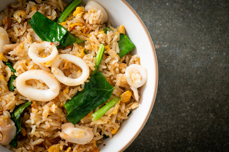 Fried rice with squid or octopus in bowl - stir-fried rice with squid, egg and kaleの写真素材