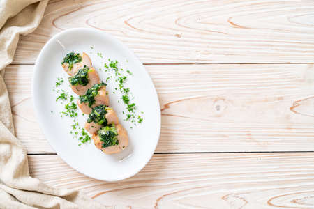 Chicken breasts stuffed with spinach and cheese on plateの写真素材