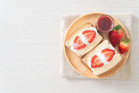 pancake sandwich strawberry fresh cream on wood plateの写真素材