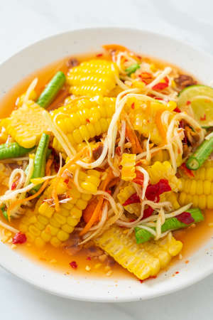 Som Tum - Thai spicy papaya salad with corn - Asian food styleの写真素材