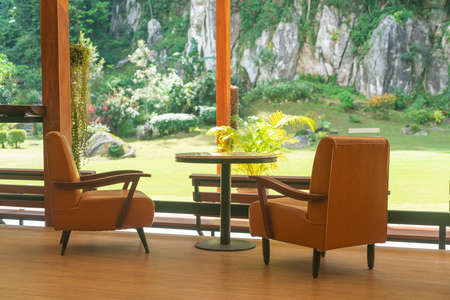 empty sofa chair with table on balcony with mountain hill backgroundの写真素材