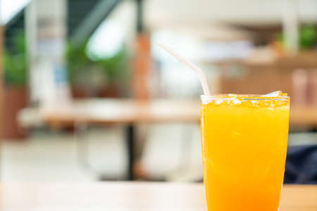 iced orange juice on wood table in cafe restaurantの写真素材