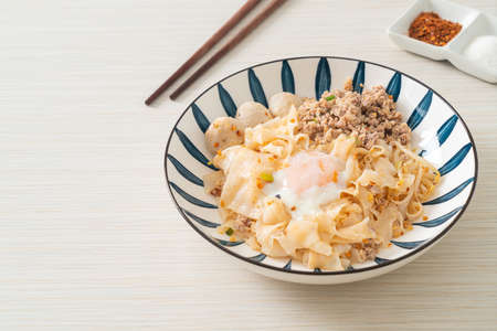 dried spicy noodles with minced pork, meatballs and egg - Asian food styleの写真素材