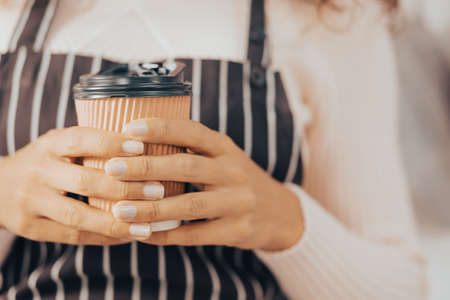 close-up hand holding hot coffee cup - vintage effect filterの写真素材