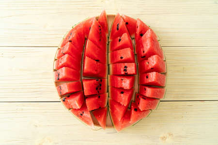 fresh watermelon sliced on wooden plateの写真素材