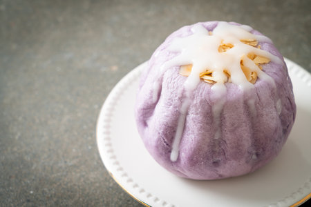 taro bun with white sugar cream and nut on topの写真素材