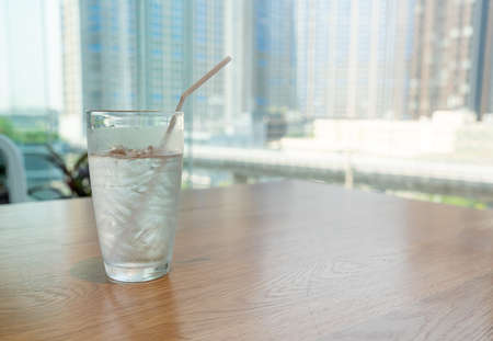 water glass with ice on tableの写真素材