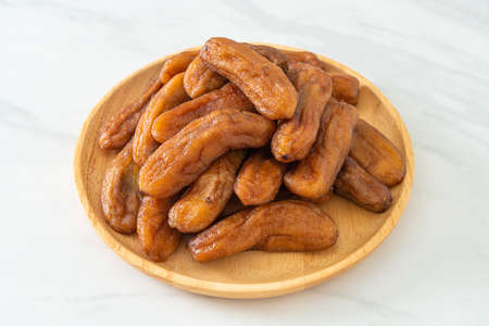 sun dried banana on wooden plateの写真素材